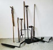 A GROUP OF TEN BYGONE HAND IMPLEMENTS TO INCLUDE SUGAR BEET PULLER, DRAIN SPADE, FLAIL, PITCH FORK,