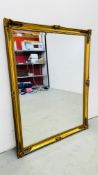 A LARGE ORNATE GILT FRAMED MIRROR 105CM X 135CM.