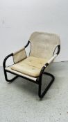 A 1930s TUBULAR STEEL FRAMED ARMCHAIR WITH CANVAS BACK AND SIDES AND A CUSHION SEAT,