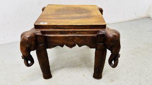 AN ORIENTAL HARDWOOD SQUARE STAND, THE BASE WITH ELEPHANTS HEADS.