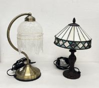 A MODERN BRASS EFFECT TABLE LAMP WITH A GLASS FRINGED SHADE + A REPRODUCTION TIFFANY STYLE LAMP -