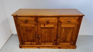 A HONEY PINE 3 DRAWER 3 DOOR SIDEBOARD W 136 X D 45 X H 86CM.