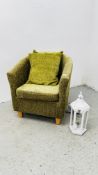 A MODERN GREEN UPHOLSTERED TUB CHAIR WITH MATCHING CUSHIONS PLUS A MODERN DECORATIVE LANTERN LIGHT.