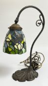 A REPRODUCTION TIFFANY STYLE TABLE LAMP WITH BUTTERFLY DETAIL - SOLD AS SEEN.