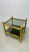 A MODERN BRASS AND SMOKED GLASS 2 TIER STAND W 56CM D 51CM.