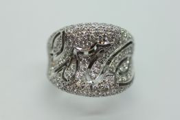 A DESIGNER HIGH GRADE WHITE METAL DESIGNER RING SET WITH DIAMONDS IN A LEAF DESIGN,