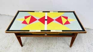 A MID CENTURY TEAK FRAMED COFFEE TABLE WITH FORMICA TOP INLAY.