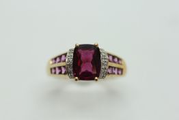 A 9CT GOLD AMETHYST RING, THE SHOULDER WORK ALSO SET WITH SMALL AMETHYSTS.