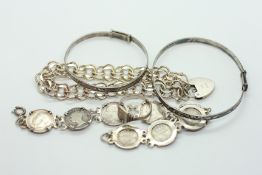 A GROUP OF 4 VINTAGE SILVER BRACELETS TO INCLUDE A COIN EXAMPLE + A SILVER SIGNET RING.