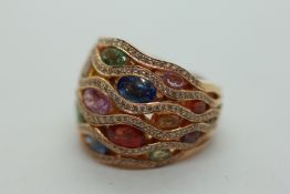 A MULTI STONE RING MARKED 750.