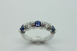 A SAPPHIRE AND DIAMOND RING, THE THREE OVAL CUT SAPPHIRES DIVIDED BY BRILLIANT CUT DIAMONDS,