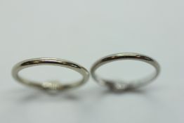 TWO PLATINUM WEDDING BANDS.