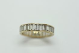 A 14KT GOLD ETERNITY RING.