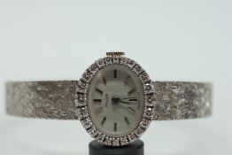 A LADY'S PARA 18CT WHITE GOLD CASED COCKTAIL WATCH ON BRAIDED BRACELET, THE BEZEL SET WITH DIAMONDS,