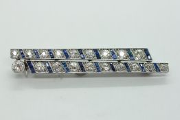 A VINTAGE WHITE METAL DOUBLE ROW BROOCH SET WITH BRILLIANT CUT DIAMONDS AND ALTERNATING BAGUETTE