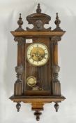 ANTIQUE MAHOGANY CASED VIENNA STYLE WALL CLOCK WITH KEY AND PENDULUM.