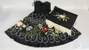 A VINTAGE BLACK SATIN DRESS HAND CRAFTED WITH EMBROIDERED SUMMER FLOWERS AND MATCHING SHAWL.