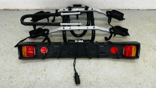 A THULE 2 BIKE CARRIER WITH TOW BALL MOUNT AND LIGHT BAR.