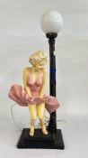 A REPRODUCTION MARILYN MONROE LAMP WITH GLASS SHADE - SOLD AS SEEN.
