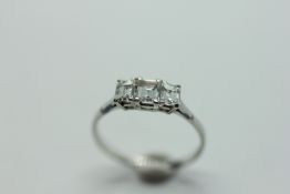 A DIAMOND TRIO RING, THE THREE BAGUETTE CUT STONES ON A PLATINUM BAND.