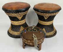 TWO ETHNIC RATTAN AND LEATHER STOOLS + AN AFRICAN WOVEN CASKET.