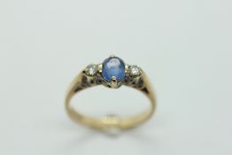 A 9CT GOLD DIAMOND AND SAPPHIRE DRESS RING.