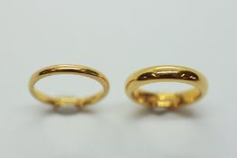 A 22CT GOLD WEDDING BAND + A 22CT GOLD LADY'S WEDDING BAND.