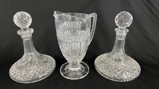 TWO GOOD QUALITY CRYSTAL GLASS SHIPS STYLE DECANTERS AND A GOOD QUALITY HEAVY CRYSTAL GLASS JUG.