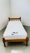 A HONEY PINE SINGLE BED FRAME ALONG WITH A SNUGGLE MATTRESS.