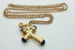 AN 18CT GOLD CROSS ON CHAIN, THE CROSS SET WITH BLUE CABOCHONS.