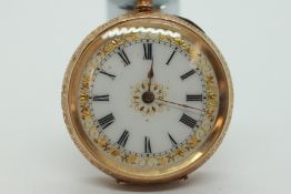 AN ANTIQUE 14K GOLD CASED FOB WATCH, ENAMEL DIAL WITH GILT DESIGN IN A FITTED VELVET LINED BOX.