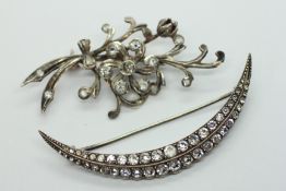 TWO VINTAGE WHITE METAL PASTE BROOCHES TO INCLUDE A HALF MOON EXAMPLE.