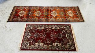 AGAKHAN HALL RUNNER ON A RED GROUND 286CM X 88CM + A PERSIAN RUG ON RED GROUND 94CM X 168CM.