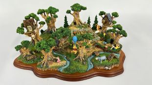 A LARGE BOXED DISNEY WINNIE THE POOH AND FRIENDS ORNAMENT DEPICTING THE HUNDRED ACRE WOOD.