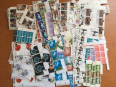 STAMPS: ENVELOPE WITH 1980's MINT COMMEMS AND MACHINS, MANY IN BLOCKS.