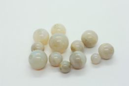 A SMALL GROUP OF POLISHED OPAL BEADS, APPROX 12.