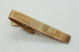 A 9CT GOLD TIE CLIP.