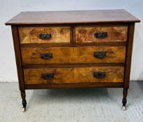 A VINTAGE MAHOGANY FINISH TWO OVER TWO DRAWER CHEST ON CERAMIC CASTERS.