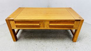 A MODERN LIGHT OAK TWO DRAWER COFFEE TABLE 120CM X 61CM.