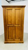 A WAXED PINE DOUBLE WARDROBE W 110CM D 54CM H 191CM.