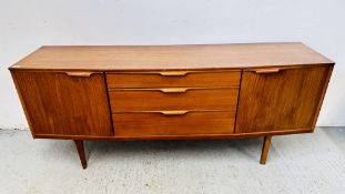 A MID CENTURY TEAK SIDEBOARD, THE THREE CENTRAL DRAWERS FLANKED BY CUPBOARDS,