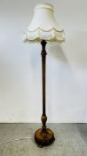 FINE QUALITY TURNED HARD WOOD LAMP STANDARD WITH CREAM FRINGED SHADE - SOLD AS SEEN.