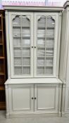 A MODERN GREY FINISH TWO DOOR BOOKCASE WITH CUPBOARD BASE, W 112CM X D 57CM X H 221CM.