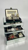 A MODERN THREE DRAWER MIRRORED GLASS JEWEL CHEST CONTAINING BEADED NECKLACES,