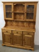 A HONEY PINE 3 DRAWER 3 DOOR DRESSER, W 141CM, D 45CM, H 187CM.