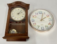 A WALL HANGING MINISTER MAHOGANY FINISH CLOCK.