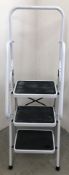 A SET OF FOLDING 3 TREAD STEPS WITH HAND RAIL.