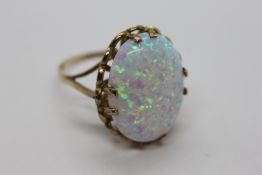 AN IMPRESSIVE 9CT GOLD RING SET WITH AN OVAL OPAL PANEL.