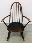 AN ERCOL STYLE LOW ROCKING CHAIR.