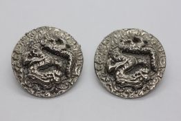 A PAIR OF VINTAGE ORIENTAL WHITE METAL CLIP ON EARRINGS RELIEF DECORATED DRAGON.